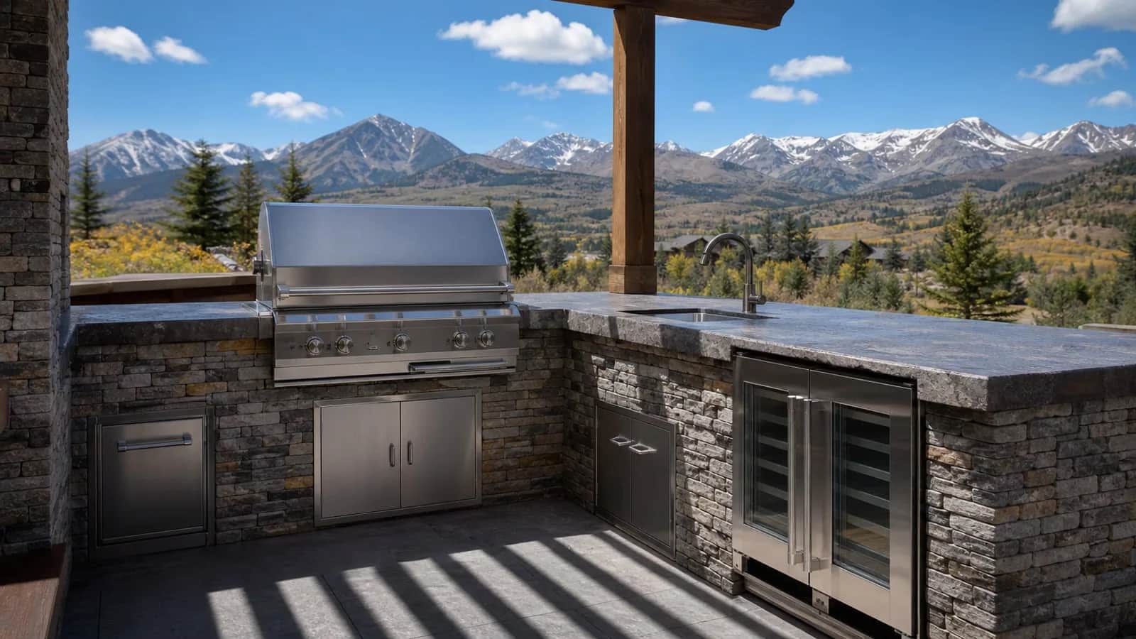 Outdoor kitchen with stone veneer and pergola in Colorado