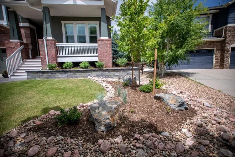 Front elevation with landscaped walk-up beds: brick base, siding, and house number 14276, Westminster.