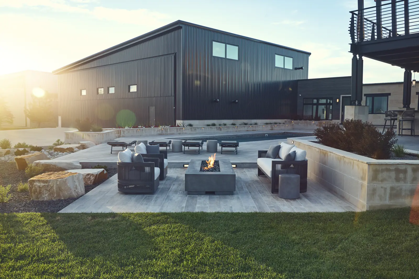 Sunset over a sunken fire lounge with outdoor sofas on the Colorado prairie