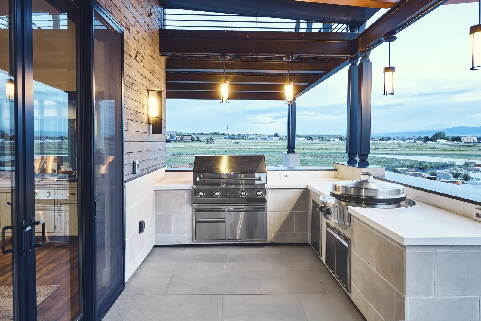 Built-in stainless grill and outdoor kitchen counters under a pergola with prairie views, Johnson Estate, Colorado