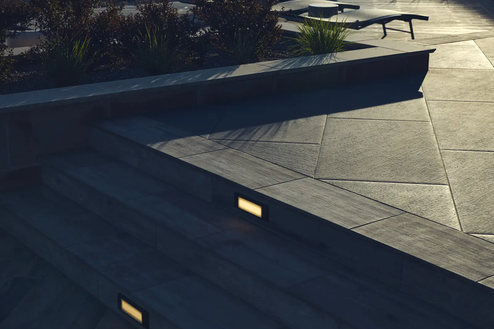 Recessed LED step light glowing in a porcelain paver stair, Johnson Estate lighting detail
