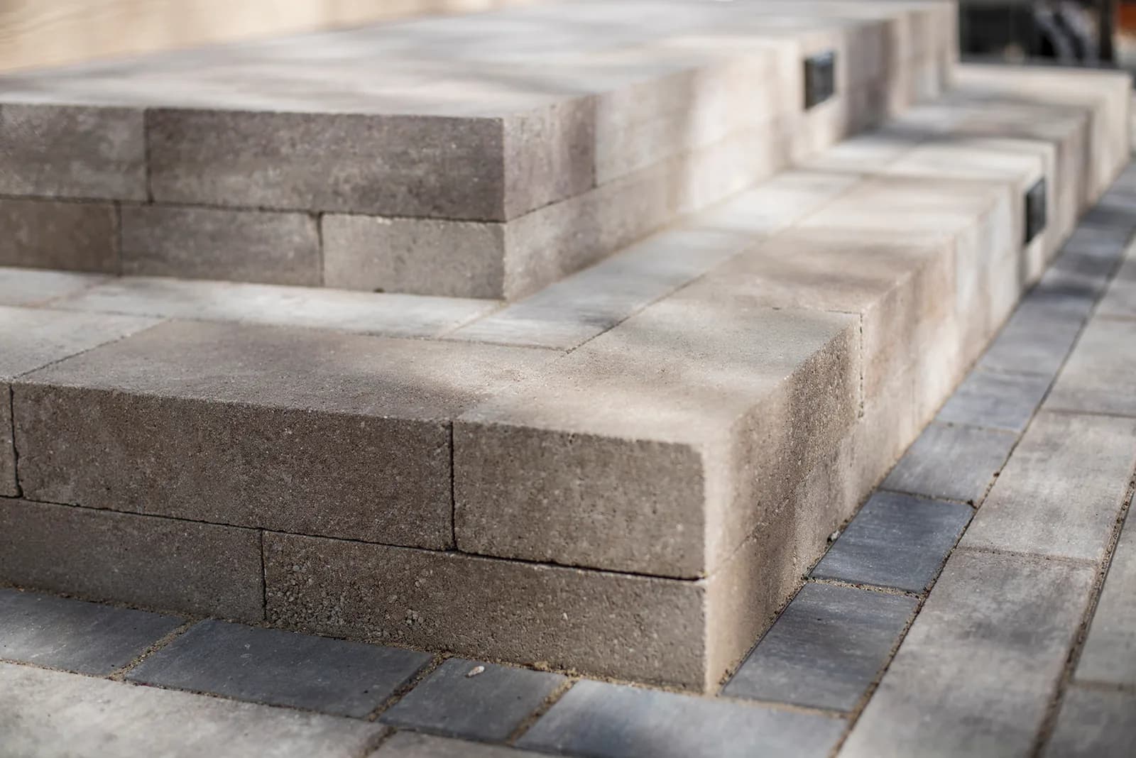Outdoor living space with paver patio and landscape lighting in Longmont, Colorado